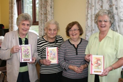 Pleased with their homemade birthday cards are, from left: Jean McClelland, Lillian Farr, tutor Rhonda Minford and Maureen Carmont.